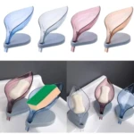 Jabonera con forma de hoja, en tonos azul, blanco, rosa y naranja, con base gris y drenaje. Ideal para baño y cocina.