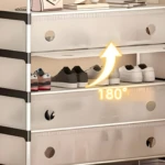 Zapatero 7 niveles blanco con diseño de flecha amarilla "180°" mostrando apertura, y varios pares de zapatillas y zapatos.