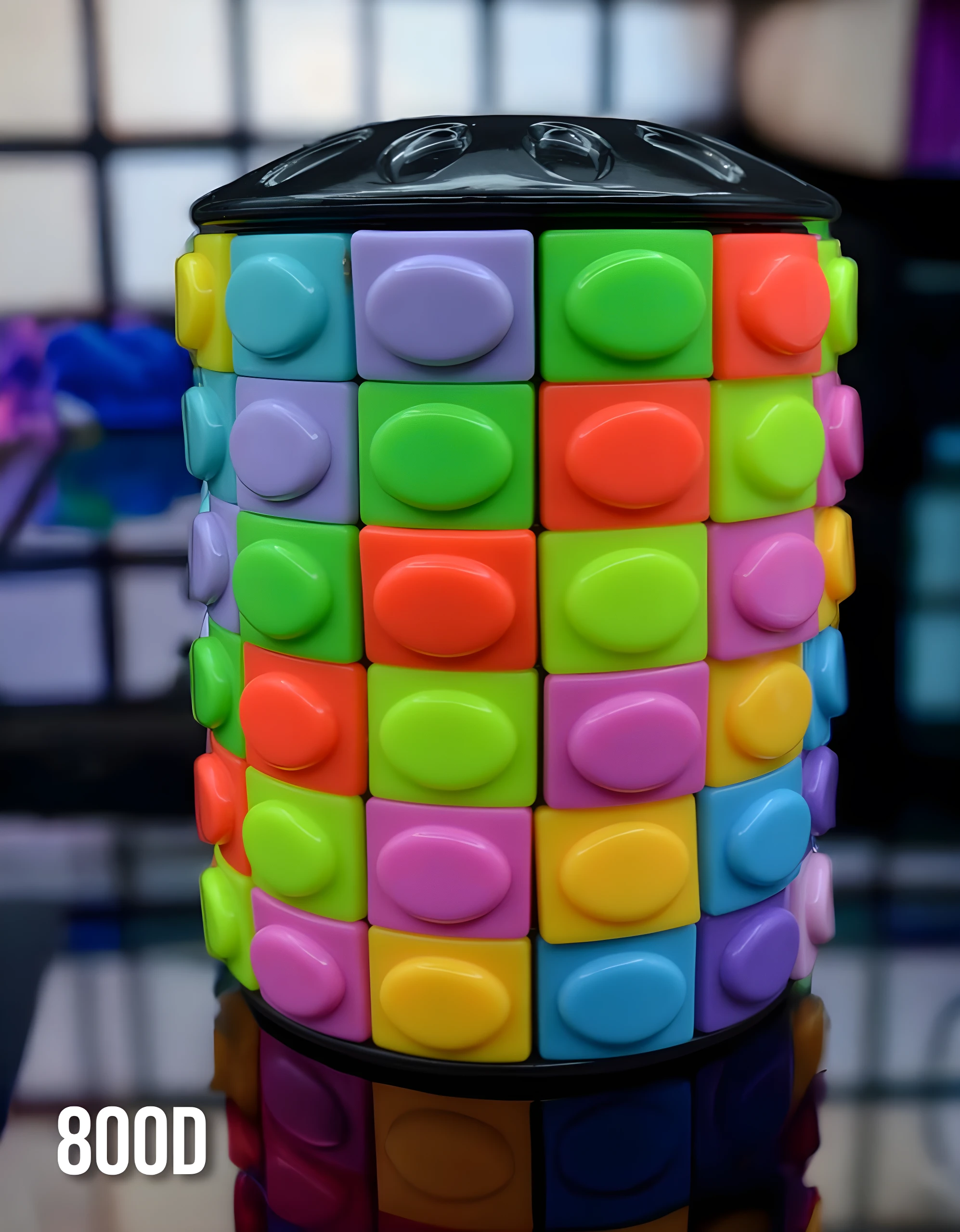 Cubo Rubik cilíndrico tipo Pop It, colores vibrantes (verde, morado, naranja, azul), tapa negra brillante. Modelo 800D.