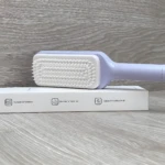 Cepillo peine retráctil de limpieza automática, color lila, para desenredar cabello.