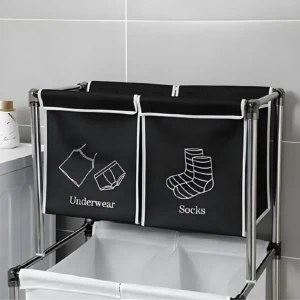 Cesta para ropa sucia negra de 2 divisiones, "Underwear" y "Socks", con estructura metálica.