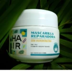 Crema reparadora capilar "Hair Ir" con Hidrokeratina, anti-frizz, 250ml, en tarro blanco rodeado de hojas verdes.