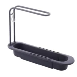 Escurridor extensible gris oscuro para fregadero, con barra superior para secar paños y gancho blanco para colgar utensilios.