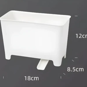 Cubo escurridor blanco para residuos de cocina con base elevada y desagüe frontal. Mide 18cm de largo, 12cm de alto y 8.5cm de profundidad.