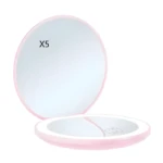 Espejo de maquillaje compacto rosa plegable con luz LED y aumento 5x.