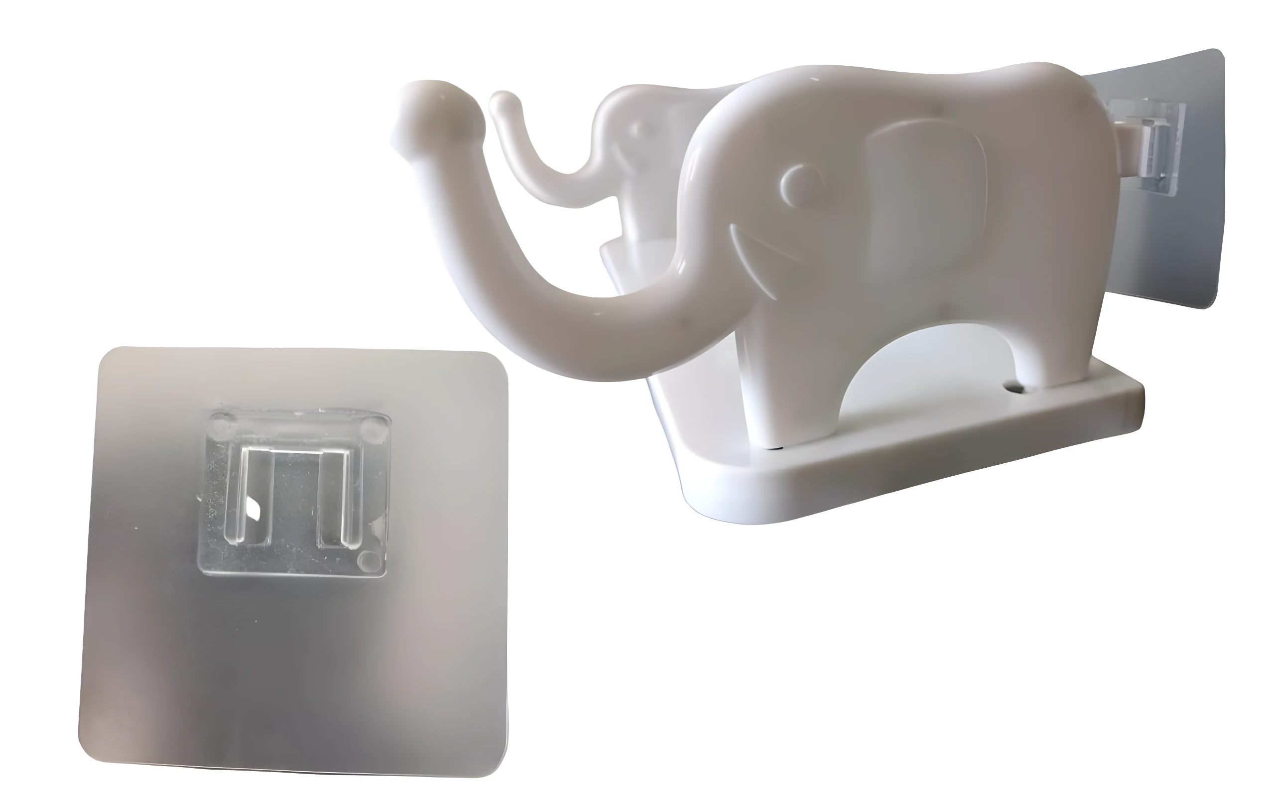Gancho pared adhesivo blanco plástico forma elefante sonriente, incluye base pegante cuadrada transparente.