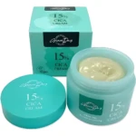 Crema facial Grace Day 15% Cica en tarro turquesa abierto mostrando textura verde clara, junto a su caja y tapa.
