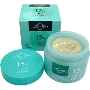 Crema facial Grace Day 15% Cica en tarro turquesa abierto mostrando textura verde clara, junto a su caja y tapa.