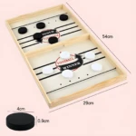 Juego de mesa Foosball de madera con discos blancos y negros. Dimensiones indicadas: 54x29 cm.