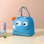 Lonchera térmica infantil azul con divertido diseño de monstruo, ideal para mantener alimentos fríos o calientes en el colegio.