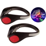 Dos luces led negras con botón rojo de encendido para calzado deportivo, con círculo insertado mostrando luces multicolor en talones de zapatillas.