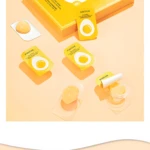 Caja amarilla con mascarillas hidratantes Jomtam en forma de huevo, para piel cansada.