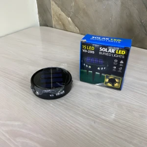 Lámpara solar enterrada para jardín, 15 LED, modelo YD-2315, color negro, con panel solar visible y luces LED en su base.