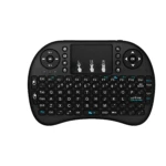 Teclado inalámbrico negro con touchpad, teclas retroiluminadas y controles de reproducción multimedia.