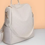 Morral blanco para dama con textura a cuadros, correa ajustable y asa superior.