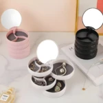 Organizador de joyas compacto apilable con espejo, disponible en rosa y negro, ideal para guardar accesorios.
