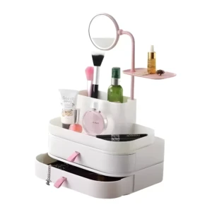 Organizador de maquillaje blanco con espejo circular rosa, cajones y compartimentos para cosméticos.