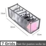 Organizador de 7 rejillas gris, malla translúcida, para guardar ropa interior, medias o corbatas. Mide 32x12x12cm.