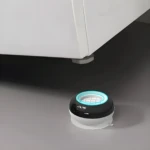Soportes antivibración de goma negra y blanca para electrodomésticos, reducen ruido y protegen suelos.