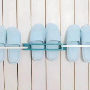 Soporte adhesivo azul para 2 pares de sandalias en pared blanca.