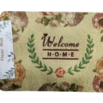 Tapete de entrada textura vinílica color beige con estampado floral tonos rojos y marrones, dice "Welcome HOME" rodeado de laurel.