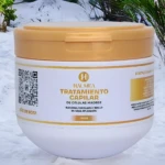 Tarro blanco con tapa dorada de tratamiento capilar Haumea de 300ml con logo y texto informativo.