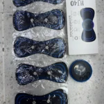 Masajeadora mini con 5 electrodos tipo mariposa en empaque transparente, caja de producto "HJ40 MINI MASSAGER" al lado.
