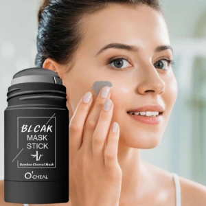 Mujer aplicándose mascarilla de carbón de bambú en barra, color gris.