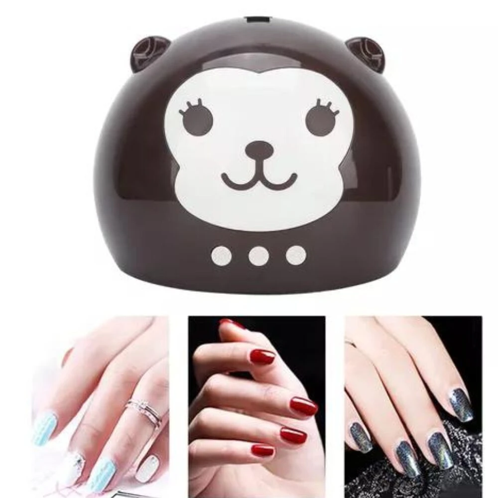 Lámpara UV LED para uñas color café con diseño de mono en ABS, acompañada de tres ejemplos de manos con esmalte decorado en diferentes tonos.