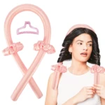 Kit de rizadora sin calor de satén rosado con pinza y dos coleteros, junto a una mujer usándolo para crear ondas definidas en su cabello oscuro.