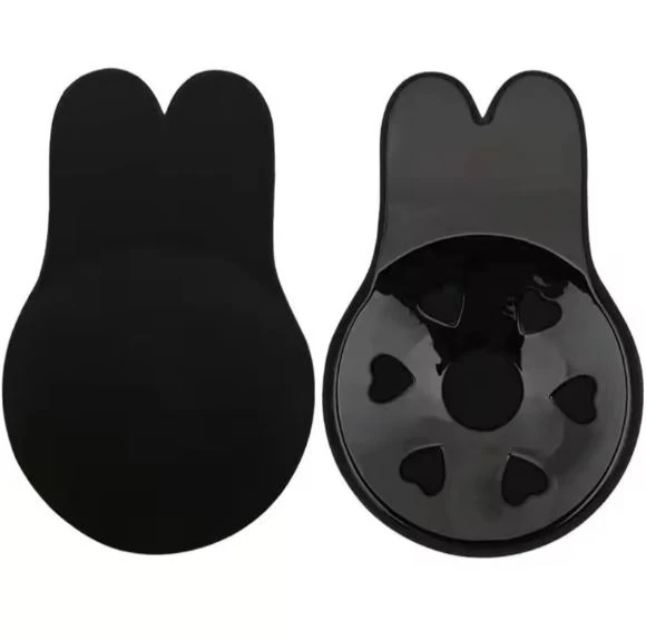 Par de sujetadores autoadhesivos de silicona negros con diseño de orejas de conejo, mostrando al lado izquierdo la superficie lisa y al derecho el interior.