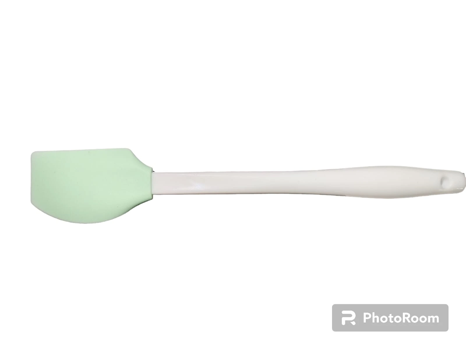 Espátula de cocina con cabezal de silicona color verde claro y mango ergonómico blanco, ideal para repostería y mezcla de ingredientes.