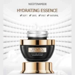 Tarro de crema hidratante Venzen con niacinamida, envase negro de tapa dorada con textura cremosa expuesta sobre fondo blanco difuminado y elegante.