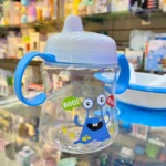 Vaso entrenador azul transparente para bebé con diseño de monstruo y asas, tapa blanca.