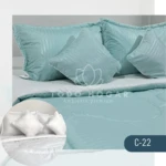 Plumón nórdico color menta con textura acanalada, dos fundas de almohada a juego y detalle de logo "Todo Hogar Ambiente premium".