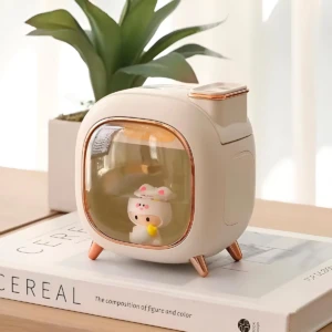Humidificador A330 beige con figura gatito LED, diseño retro, sobre libro.