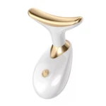 Máquina lifting facial blanca con detalles dorados, diseño ergonómico en forma de U y botón de encendido visible.