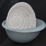 Set x2 colador y escurridor plástico gris y blanco con diseño perforado para drenar agua.