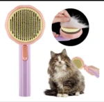 Cepillo para mascota rosa y lila. Ideal para remover pelo suelto. Incluye accesorio para limpieza fácil.