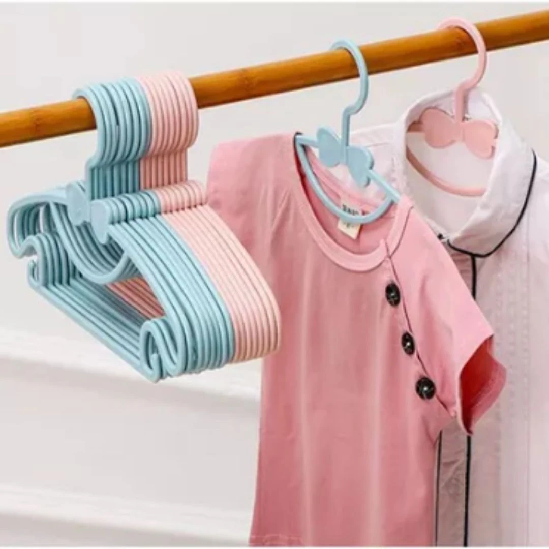 6 ganchos flexibles para ropa de bebé, azul y rosa pastel, con diseño de moño, para colgar ropa infantil.