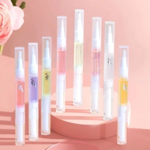 Set de siete aceites para cutícula en lápices aplicadores transparentes con diferentes esencias y colores, exhibidos verticalmente sobre una base circular.