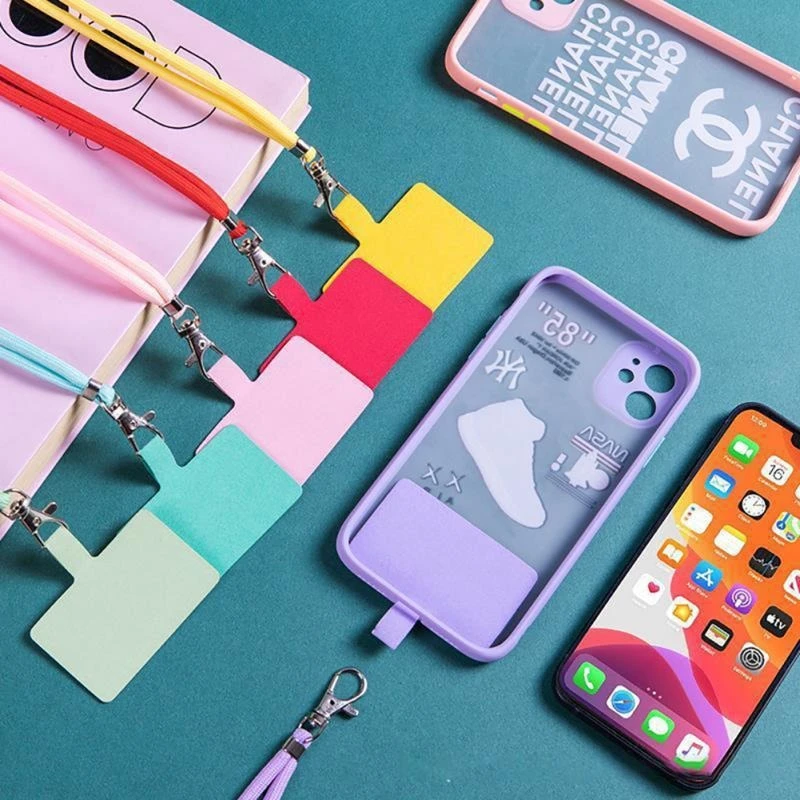 Cordon de seguridad para celular con lanyards de colores: amarillo, rojo, rosa, azul y verde claro, con accesorios de sujeción.