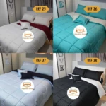 Edredón doble faz de líneas finas en blanco, turquesa, azul y negro para cama doble.