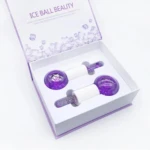 Set x2 masajeadores faciales de hielo con brillos morados, presentados en caja abierta.