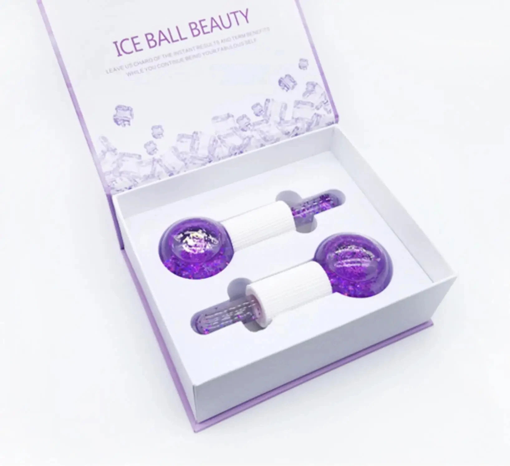 Set x2 masajeadores faciales de hielo con brillos morados, presentados en caja abierta.