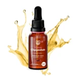 Tónico despigmentante facial LB en frasco de vidrio ámbar con gotero, rodeado por salpicaduras doradas de líquido. Contenido de 30 ml para todo tipo de piel.