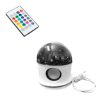 Lámpara proyector de estrellas con altavoz Bluetooth y mando a distancia, base blanca con altavoz circular y cable de conexión a corriente integrado.