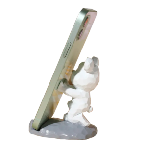 Soporte para celular en forma de oso blanco abrazando un teléfono verde sobre base gris.