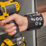 Pulsera magnética negra con tornillos, tuercas y puntas de taladro. Ideal para trabajos con herramientas.