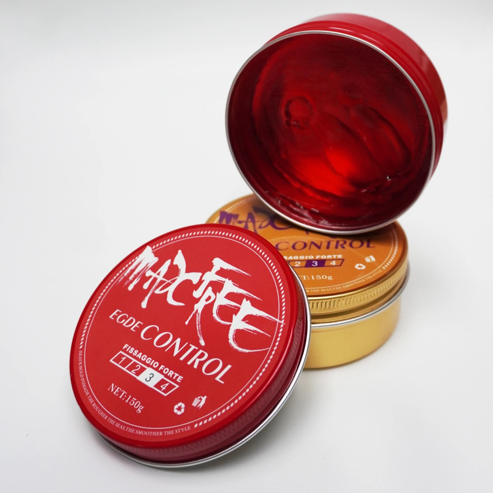 Set de dos ceras para cabello MacFee Edge Control de 150g. Un envase rojo abierto muestra la textura del gel, junto a otro contenedor dorado apilado.